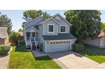 Charming two-story home with inviting front porch and well-maintained lawn at 3755 Shefield Dr, Broomfield, CO 80020