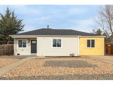 Charming home featuring stone landscaping, clean siding, and a well-kept yard at 855 Newark St, Aurora, CO 80010