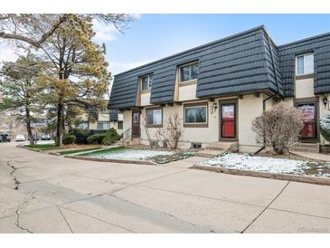 Two-story townhouse with striking mansard roof, red door, and minimal landscaping at 6838 S Broadway, Centennial, CO 80122