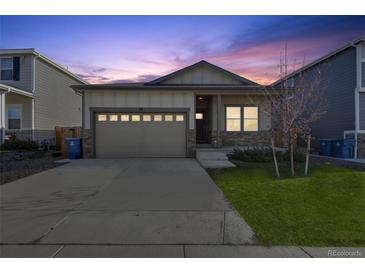 Charming single Gathering home featuring an attached two car garage and beautiful landscaping at 98 Chipeta Way, Lochbuie, CO 80603