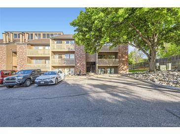 A charming multi-story condo complex features balconies, well-maintained landscaping, and convenient parking at 12368 W Nevada Pl # 206, Lakewood, CO 80228