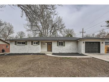 Charming single-story home featuring a white brick exterior, dark shutters, and a well-maintained front yard at 9455 W 37Th Ave, Wheat Ridge, CO 80033