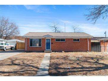 Charming single-story brick home with a well-maintained front yard on a sunny day at 2738 Xanadu St, Aurora, CO 80011