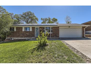 Charming brick home featuring solar panels and a well-manicured lawn, perfect for energy efficiency and curb appeal at 8258 Cherokee St, Denver, CO 80221