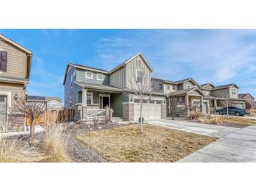 Beautiful two-story home featuring a two-car garage, manicured lawn, and inviting curb appeal at 1066 S Eaton Park Ct, Aurora, CO 80018