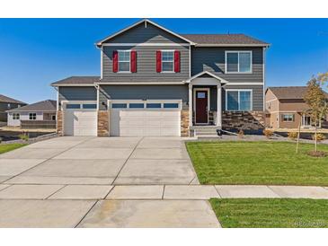 Two-story house with gray siding, red shutters, and a three-car garage at 3274 Belleville Ridge Rd, Elizabeth, CO 80107