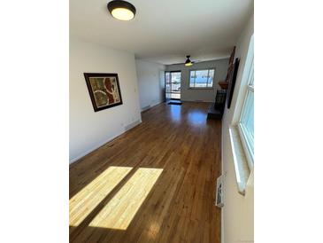 Bright living room with hardwood floors and natural light at 6213 Gray St, Arvada, CO 80003