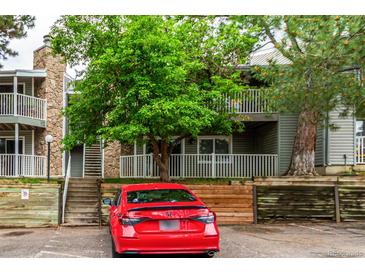 Multi-level condo with stone accents, mature landscaping, and ample parking at 910 S Walden St # 106, Aurora, CO 80017