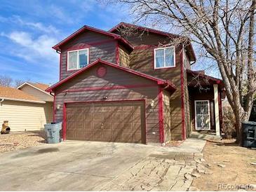 Charming two-story house featuring a spacious two-car garage and well-maintained lawn at 363 Wadsworth Cir, Longmont, CO 80504