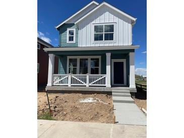 Charming two-story home with a modern color scheme and inviting front porch at 725 Cottonwood Ave, Bennett, CO 80102