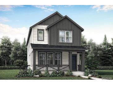 Charming two-story home with a covered front porch and manicured landscaping surrounded by mature trees at 725 Cottonwood Ave, Bennett, CO 80102