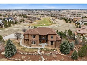 Beautiful two-story home featuring a tile roof, manicured landscaping, and proximity to a golf course at 5261 Sedona Dr, Parker, CO 80134