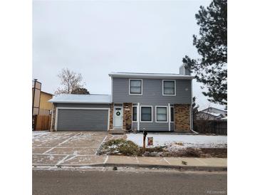 Charming two-story home featuring a gray exterior, attached garage, and welcoming front entrance at 17421 E Grand Ave, Aurora, CO 80015