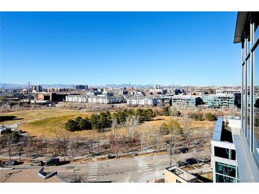 Expansive city view with distant mountains visible from the building's balcony and windows at 1700 Bassett St # 1008, Denver, CO 80202