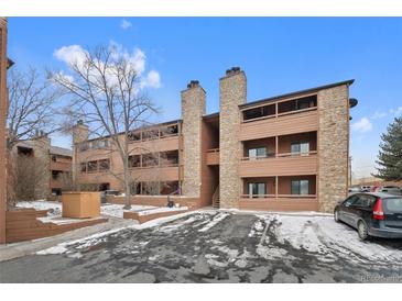Three story condo building features stone accents and private balconies at 4691 S Decatur St # 212, Englewood, CO 80110