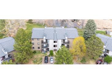 Aerial shot of condominiums with landscaping and parking lot on a sunny day in a desirable location near a river at 6505 Kalua Rd # 204B, Boulder, CO 80301
