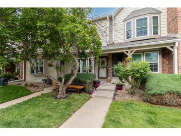 Charming townhome exterior with a well-manicured lawn and inviting front entrance at 9620 W Chatfield Ave # D, Littleton, CO 80128