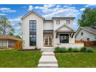 Beautifully designed two-story home with a manicured lawn and modern architectural details at 1620 S Ogden St, Denver, CO 80210