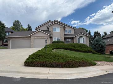 Charming two-story home with a well-manicured lawn and attached two car garage at 20886 Parliament Pl, Parker, CO 80138