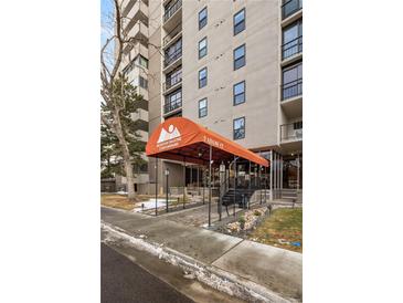 Mountain Shadows Condominiums feature a covered entrance with an orange awning and manicured landscaping at 2 Adams Street # 108, Denver, CO 80206