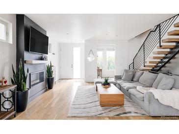 Bright living room with hardwood floors, modern fireplace, and contemporary decor at 2685 S Acoma St, Denver, CO 80223