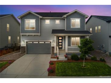 Charming two-story home with a well-manicured lawn and welcoming front porch at 52 Simmental Loop, Castle Rock, CO 80104