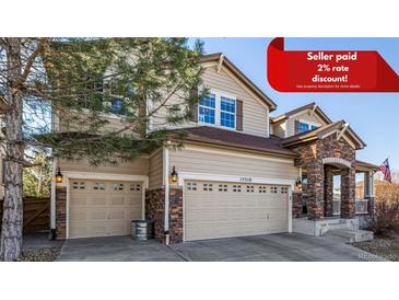 Inviting two-story home features a three-car garage, stone accents, neutral siding, and well-maintained landscaping at 15310 E 108Th Way, Commerce City, CO 80022