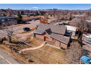 Inviting home with a red door and a combination of stone and stucco exterior at 3801 Oak St, Wheat Ridge, CO 80033