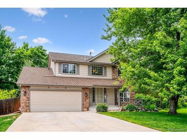 Charming two-story home with a well-manicured lawn and a two car garage, perfect for suburban living at 5721 S Jellison St, Littleton, CO 80123