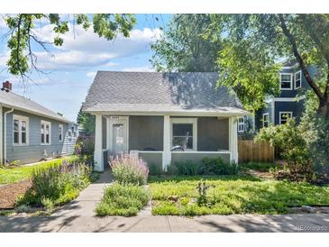 Charming home featuring a covered front porch and lovely landscaping at 3968 Winona Ct, Denver, CO 80212