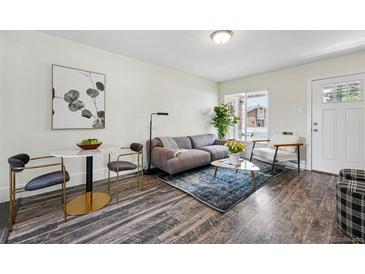 Bright living room featuring modern decor, hardwood floors, and ample natural light at 2821 N Harrison St, Denver, CO 80205
