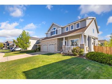 Charming two-story home with a well-manicured lawn and a two-car garage at 16478 Marion St, Thornton, CO 80602