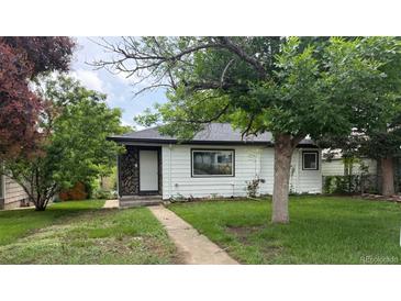 Charming single-story home with stone accents and a well-maintained lawn, situated in a quiet neighborhood at 5008 Alcott St, Denver, CO 80221