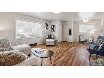 Bright living room with hardwood floors and large window allows for lots of natural light at 5008 Alcott St, Denver, CO 80221
