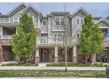 Charming two-story townhome with a covered entryway and beautifully landscaped front yard, offering curb appeal at 5435 W 97Th Pl, Broomfield, CO 80020