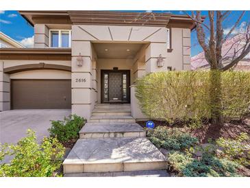 Inviting home entrance with stone steps and meticulously maintained landscaping adds curb appeal at 2616 E Cherry Creek South Dr, Denver, CO 80209
