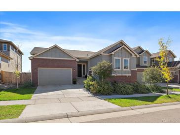 Attractive ranch home with a two-car garage, landscaping, and a welcoming front porch at 672 W 128Th Pl, Westminster, CO 80234