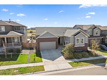 Inviting gray home featuring manicured landscaping and a convenient two-car garage, ideal for modern living at 672 W 128Th Pl, Westminster, CO 80234