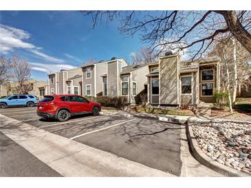 View of the exterior of a multi-unit building with assigned parking and manicured landscaping at 4634 S Fraser Ct # F, Aurora, CO 80015