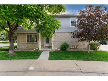 Charming home featuring a well-maintained lawn and an inviting entrance with beautiful mature trees at 1385 W 112Th Ave # D, Denver, CO 80234