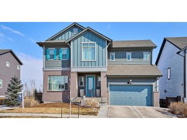 Charming two-story home featuring a blend of modern architecture and inviting curb appeal on a sunny day at 6690 Mariposa St, Denver, CO 80221