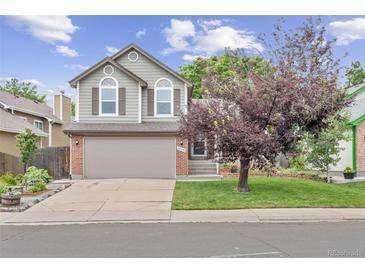 Charming two-story home with a two-car garage, brick accents, and a well-manicured front lawn at 12193 Deerfield Way, Broomfield, CO 80020