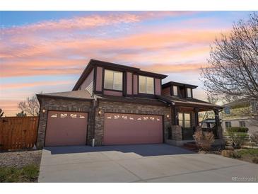 Inviting two-story home featuring a brick facade and a spacious three-car garage at 20087 E Dartmouth Dr, Aurora, CO 80013
