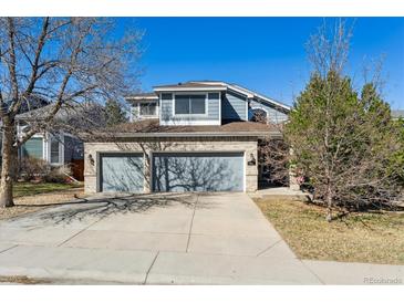 Charming two-story home with a brick facade and a spacious three-car garage, perfect for a growing Gathering at 19431 E Hamilton Pl, Aurora, CO 80013