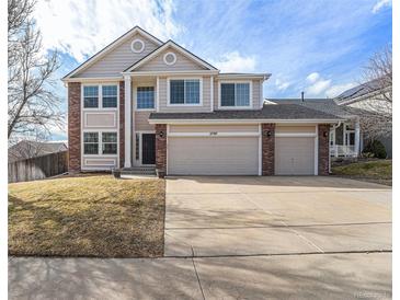 Charming two-story home with three-car garage, brick accents, and manicured front lawn at 5797 S Shawnee St, Aurora, CO 80015