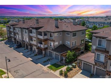 Aerial view of a townhome community with a sunset in the background at 16700 Las Ramblas Ln # O, Parker, CO 80134