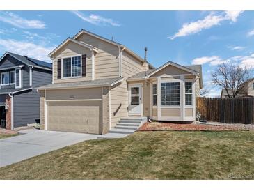 Charming two-story home with attached garage and well-maintained lawn in a suburban neighborhood at 338 Chelsea St, Castle Rock, CO 80104