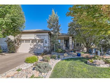 Charming home featuring a well-manicured front yard with mature trees and inviting curb appeal at 4285 Corte Bella Dr, Broomfield, CO 80023