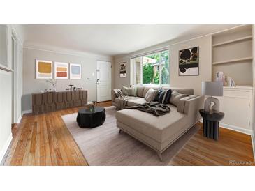Inviting living room featuring a large sectional, wood floors, and abundant natural light at 1535 Hudson St # 1, Denver, CO 80220