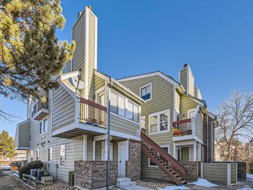 Tan multi-unit building with stairs and balconies at 932 S Dearborn Way # 8, Aurora, CO 80012